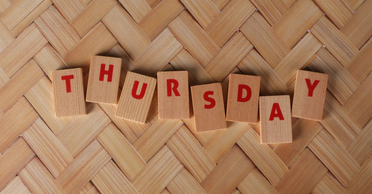 Thursday spelled out with wooden blocks on a woven pattern surface, offering a natural texture.